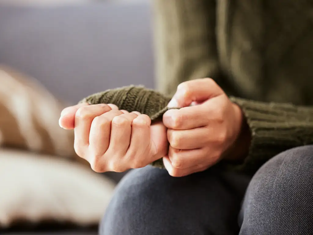 Close-up of a person's tightly clasped hands, representing anxiety treated in individual therapy in Hammonton, New Jersey.